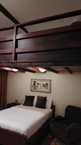 Una cama o camas en una habitación de Hotel Casa San Rafael