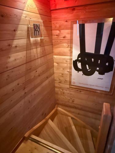 a sauna with a wooden floor and a sign on the wall at Grange de Fonville - Evolène - Valais in Evolène