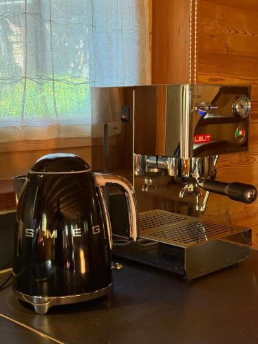 a coffee maker sitting on top of a kitchen counter at Grange de Fonville - Evolène - Valais in Evolène