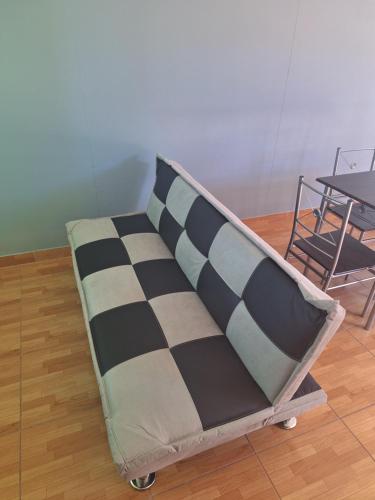 a couch with two pillows on it in a room at Casa Familiar La Rose in San Pedro de Atacama