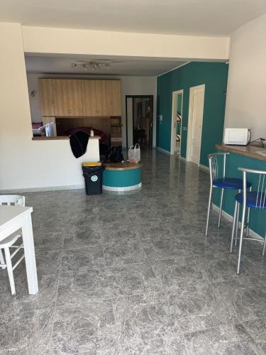 a living room with a kitchen and a table and chairs at rosy house in Scalea