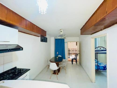 a kitchen and dining room with a table and chairs at APARTAMENTO RODADERO MIRAMAR In in Gaira