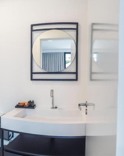 a bathroom with a white sink and a mirror at Loft Bamberg 202-Pomerode in Pomerode