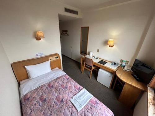 a hotel room with a bed and a desk and a computer at Hotel Tetora Hachinohe - Vacation STAY 38056v in Hachinohe