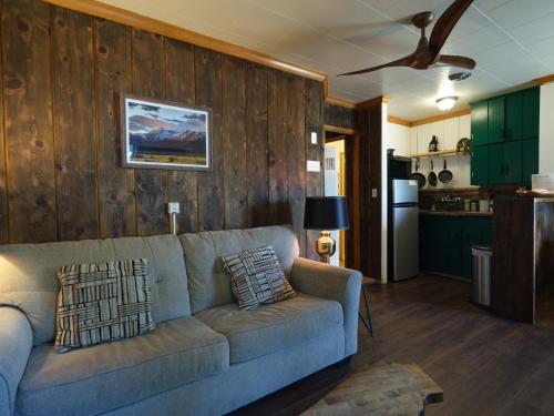 a living room with a couch and a kitchen at Lake Front Cabins in June Lake