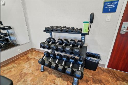 a rack full of dumbbells in a room at Cobblestone Hotel & Suites - Russells Point at Indian Lake in Russells Point
