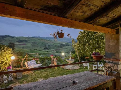 a porch with a table and a view of the mountains at Villa aperta campagna in Nicosia