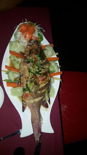 a plate of food with a fish and vegetables at Maafushi View in Maafushi