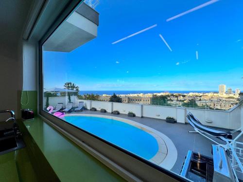a view of a swimming pool from a balcony at St Julians Hillside villa with Pool in Is-Swieqi
