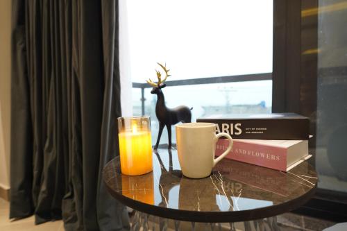 a table with a glass of orange juice and a coffee mug at The Khushi Hotel And Resorts in Murree