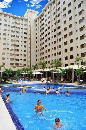 a group of people in the swimming pool at a hotel at Boulevard Suíte Hotel by WAM Experience in Caldas Novas