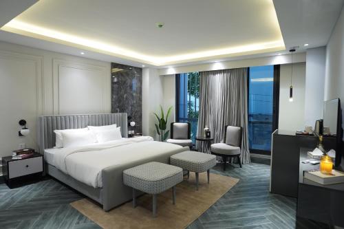 a hotel room with a bed and a television at The Khushi Hotel And Resorts in Murree