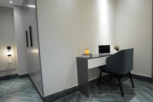 a desk with a laptop on it in a room at The Khushi Hotel And Resorts in Murree