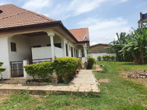 a house with a walkway leading into a yard at Adunni Court in Ilesa