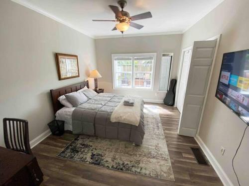 a bedroom with a bed and a ceiling fan at Atlanta Lounge in Midtown in Atlanta