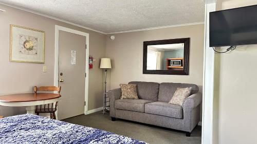 a living room with a couch and a table at Mount Blue Motel in Farmington