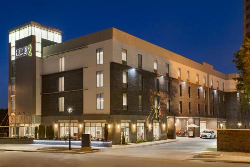 a large building with a parking lot in front of it at Home2 Suites by Hilton Greenville Downtown in Greenville