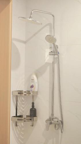 a shower in a bathroom with two shelves at Peache house in Ruaka