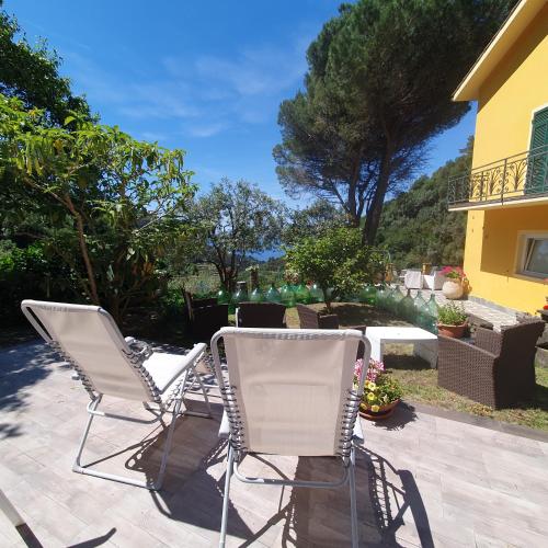 two chairs sitting on a patio in front of a house at Agriturismo Costa di Campo in Vernazza