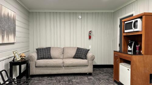 a living room with a couch and a microwave at Mount Blue Motel in Farmington