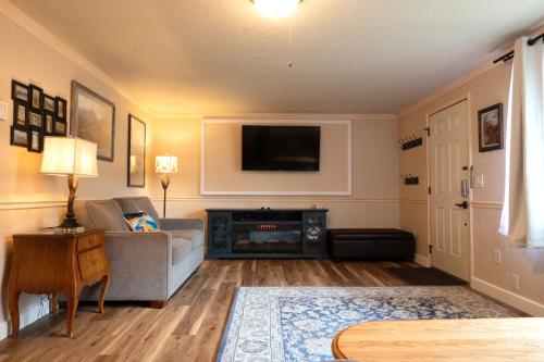 a living room with a couch and a flat screen tv at Yellowstone Gateway Inn in Gardiner