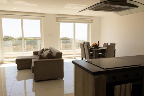 a living room with a couch and a table at Sunset and Seaview Apartment No 4 in Mellieħa
