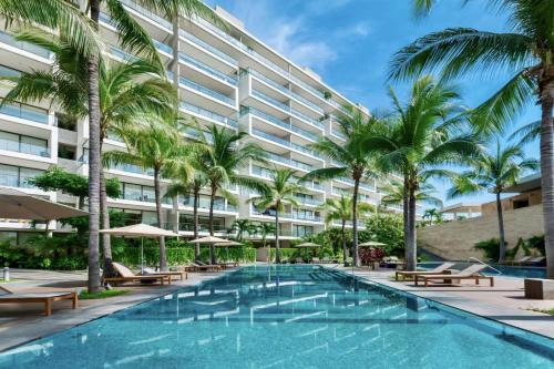 an image of a hotel with a swimming pool and palm trees at Nima Bay, Marina Vallarta in Puerto Vallarta