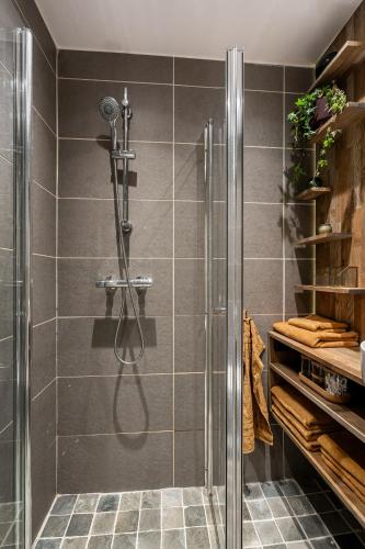 a shower with a glass door in a bathroom at VillaView Cabin in Oslo