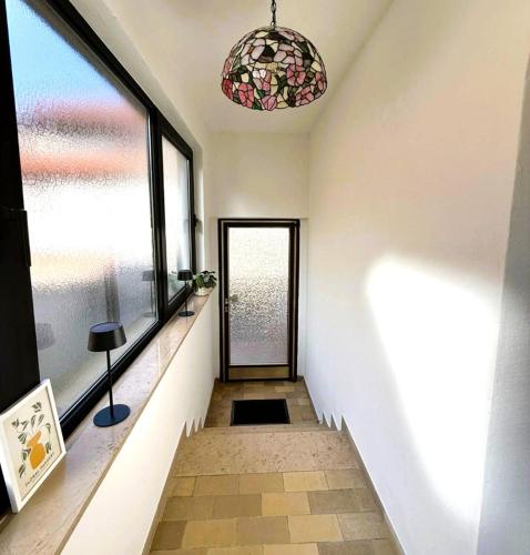 a hallway with a glass door and a window at Wohlfühl-Apartment in der Villa "Schöne Aussicht" in Rodalben