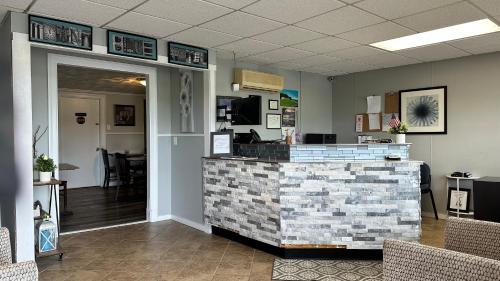 a lobby of a salon with a counter and chairs at Mount Blue Motel in Farmington