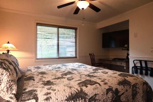 a bedroom with a bed and a ceiling fan at Yellowstone Gateway Inn in Gardiner