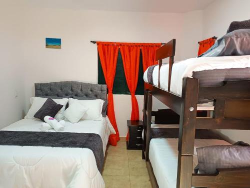a room with two bunk beds and a couch at Apartahotel Balcones de Nariño 3 in Villa de Leyva