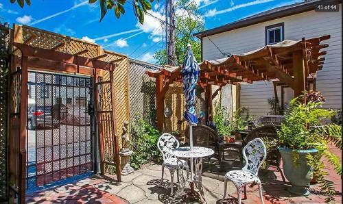 a patio with a gate and chairs and a fence at Victorian Modern Room in Carriage House - Unit B in Savannah