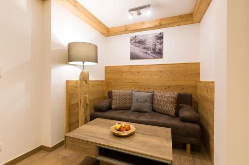 a living room with a couch and a table at Altroiterhof in St. Wolfgang