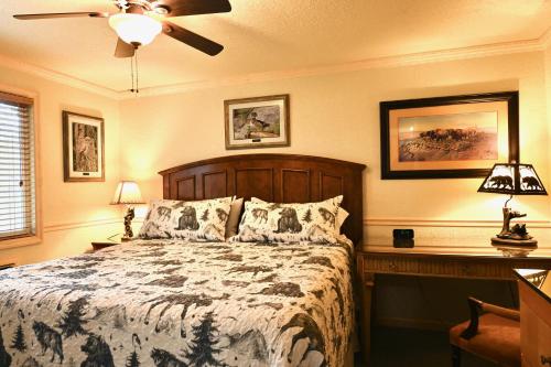 a bedroom with a bed and a ceiling fan at Yellowstone Gateway Inn in Gardiner