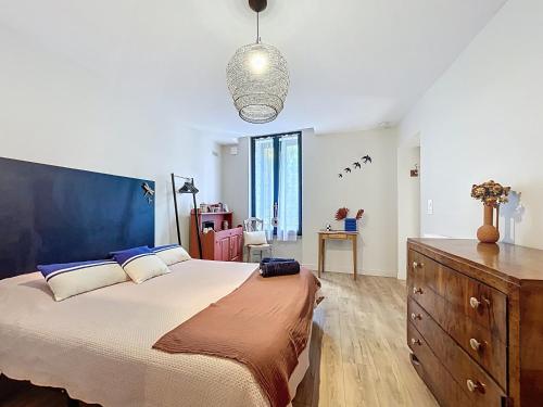 a large bedroom with a large bed and a dresser at Maison 23 in Coursan