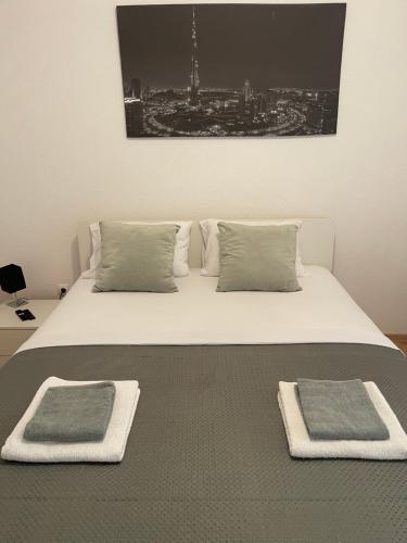 a bedroom with a bed with two towels on it at House and pool BajNa in Mostar