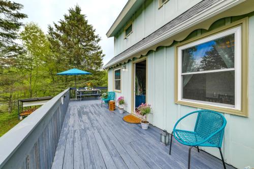 a deck with chairs and an umbrella on a house at Mountain-View Catskills Casita Hike, Fish and Golf! in Denver