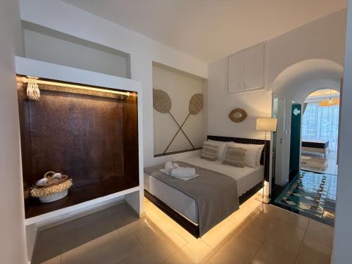 a bedroom with a bed and a large window at Amelia Seaview Apartments & Studios in Kallithea Halkidikis
