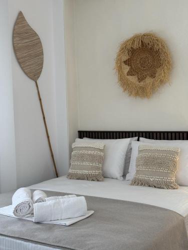 a bedroom with a bed with towels on it at Amelia Seaview Apartments & Studios in Kallithea Halkidikis