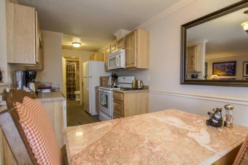 a kitchen with a table and a mirror on the wall at Yellowstone Gateway Inn in Gardiner