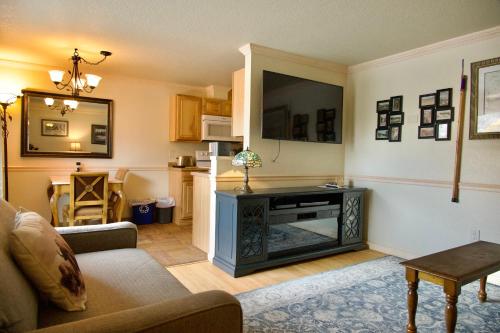 a living room with a couch and a television at Yellowstone Gateway Inn in Gardiner