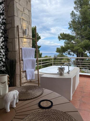 a bath tub sitting on top of a patio at Amelia Seaview Apartments & Studios in Kallithea Halkidikis