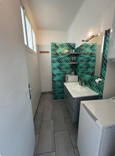 une salle de bain avec un lavabo et un miroir dans l'établissement - appartement-du-centre-ville, à Nice