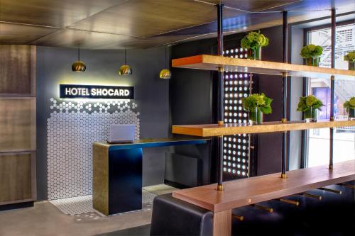 a hotel lobby with a desk and a sign that reads hotel singapore at Hotel Shocard Broadway, Times Square in New York