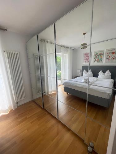 a bedroom with a bed and a large mirror at Rose Garden Retreat Private Terrace Baden-Baden in Baden-Baden