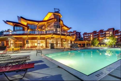 a large swimming pool in front of a building at Kelowna family-friendly lake & Mountain view Luxury condo with AC, pool, Hot tub, near winery and shopping center in West Kelowna