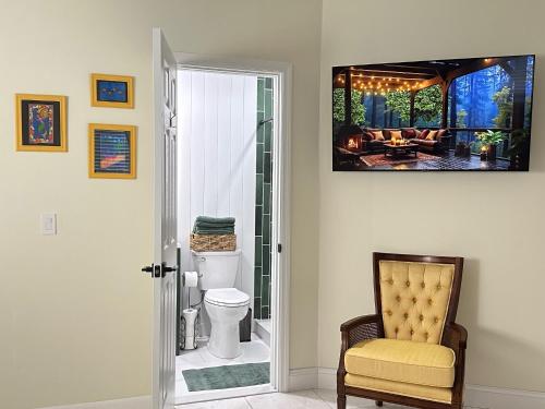 a living room with a television on the wall at Magic Secluded Suite-Pool-Sauna plus Lake View Venice Florida in Venice