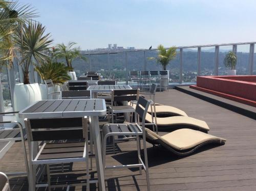 a row of chairs and tables on a roof at Hotel Belo Grand Morelia in Morelia