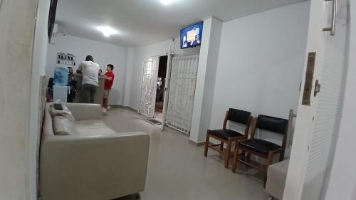 a room with two people standing in a room at Hotel Central La Jagua in La Jagua de Ibirico